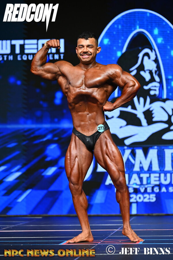 Tony Manzo posing on stage at the Amateur Olympia Las Vegas 2025