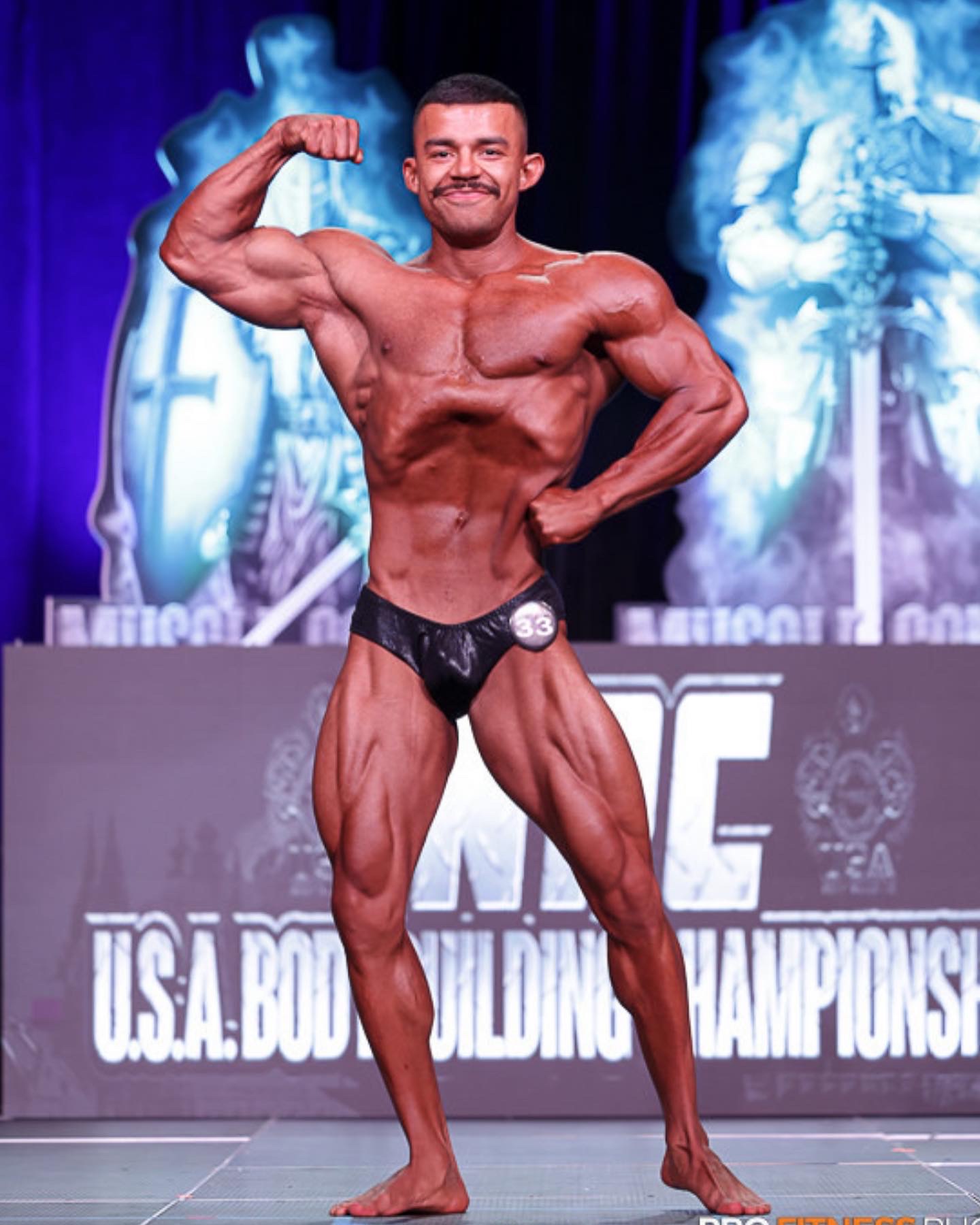 Tony Manzo posing on stage at the USA Bodybuilding Championships